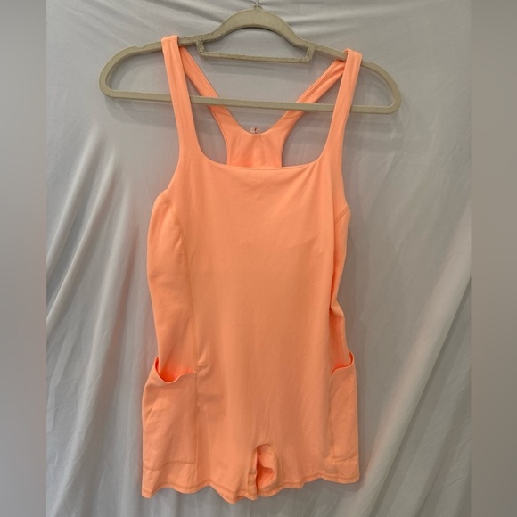 Free people movement Runsie peach light orange sz large NWOT Atheltic onesie - Picture 1 of 5